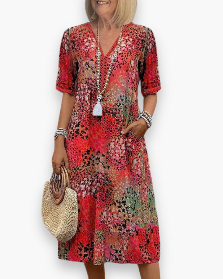 "Robe midi élégante pour femme avec imprimé raffiné, coupe flatteuse et poches pratiques, idéale pour toute occasion."