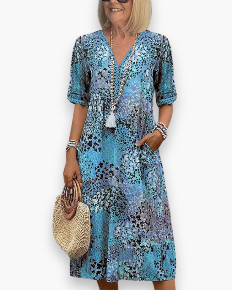 "Robe midi élégante pour femme avec imprimé raffiné, coupe flatteuse et poches pratiques, idéale pour toute occasion."