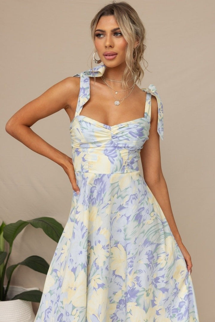 Robe midi fleurie, bretelles nouées, style bohème. Imprimé floral, coupe fluide et légère.  Parfait pour l'été.