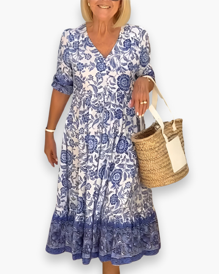 "Robe midi fleurie élégante femme, col en V, motif floral, coupe fluide, style estival, idéale pour journées ensoleillées."