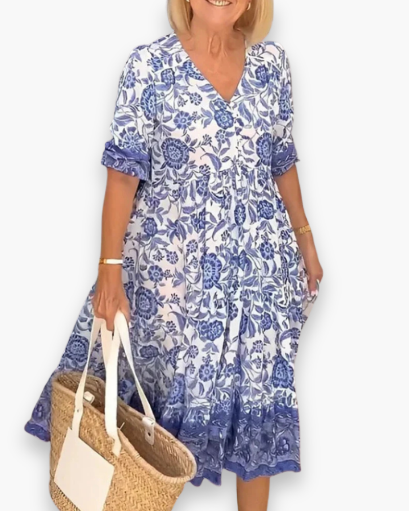 "Robe midi fleurie élégante femme, col en V, motif floral, coupe fluide, style estival, idéale pour journées ensoleillées."