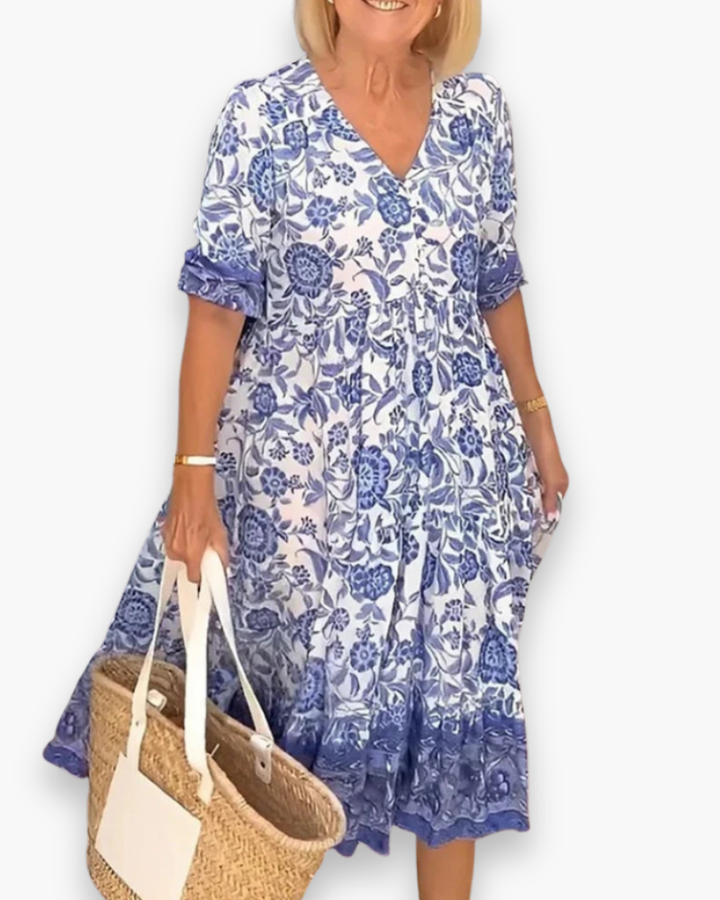 "Robe midi fleurie élégante femme, col en V, motif floral, coupe fluide, style estival, idéale pour journées ensoleillées."