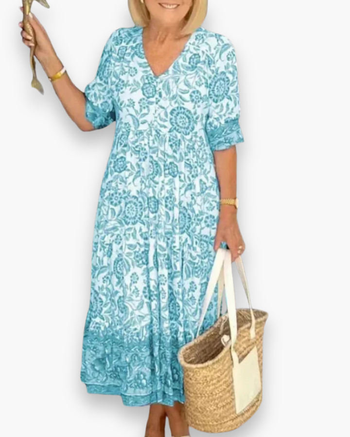 "Robe midi fleurie élégante femme, col en V, motif floral, coupe fluide, style estival, idéale pour journées ensoleillées."