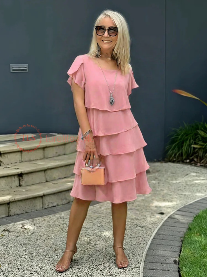 Vue d'une robe midi fluide pour femme, ourlet asymétrique, design superposé, manches courtes.
