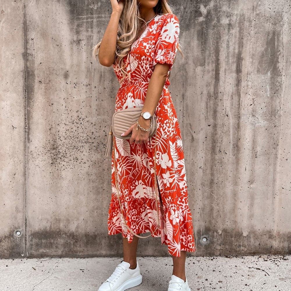 "Robe midi portefeuille rouge en coton avec motif tropical blanc, décolleté en V, manches courtes, silhouette enveloppante."