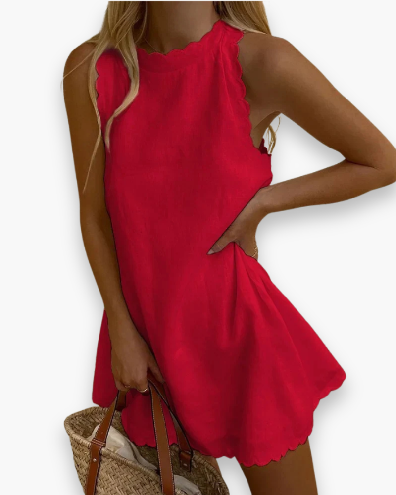 "Robe mini d'été ondulée, élégante et fluide, couleur vive, parfaite pour journées ensoleillées et sorties estivales."