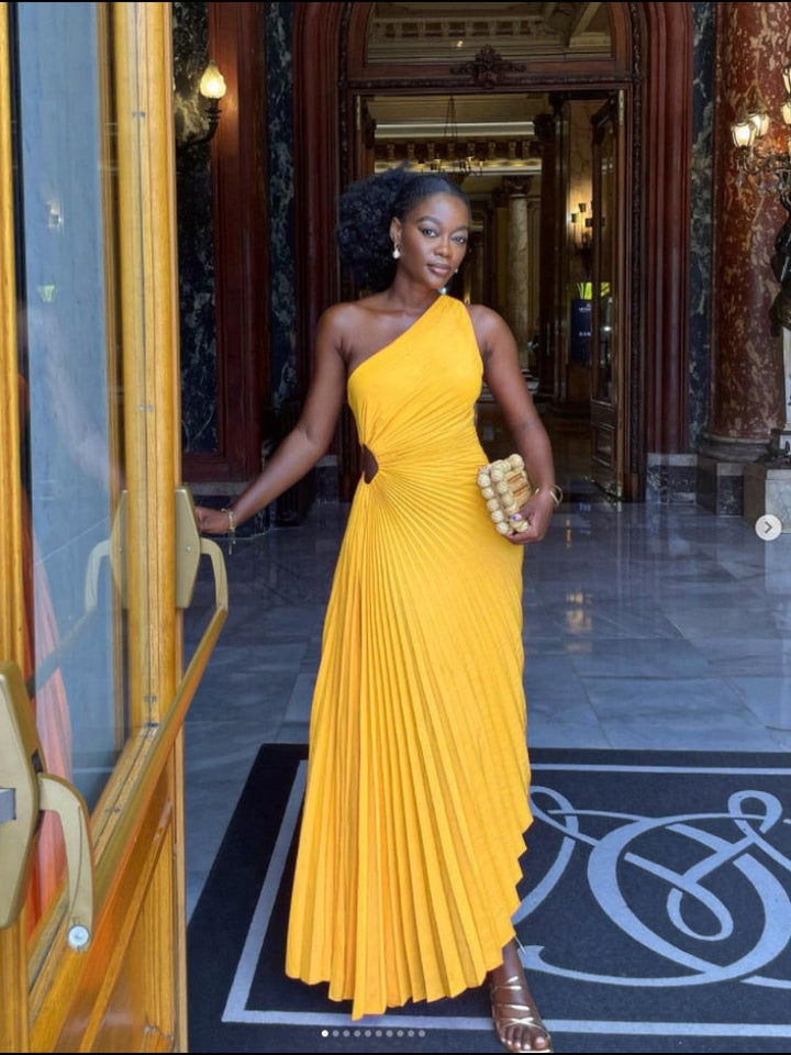 "Robe Regina longue, élégante, aux couleurs vibrantes, en tissu satiné, mettant en valeur la silhouette féminine."