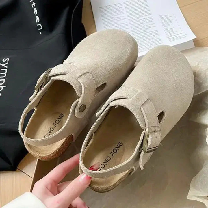 Sabots confortables femme en daim rose avec boucle ajustable. Semelle liège, style décontracté, idéal quotidien.
