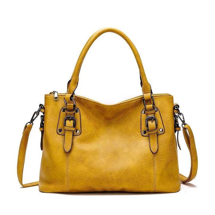 Sac à bandoulière en cuir azure, chic et résistant, avec sangle ajustable et fermeture magnétique, parfait pour femme.