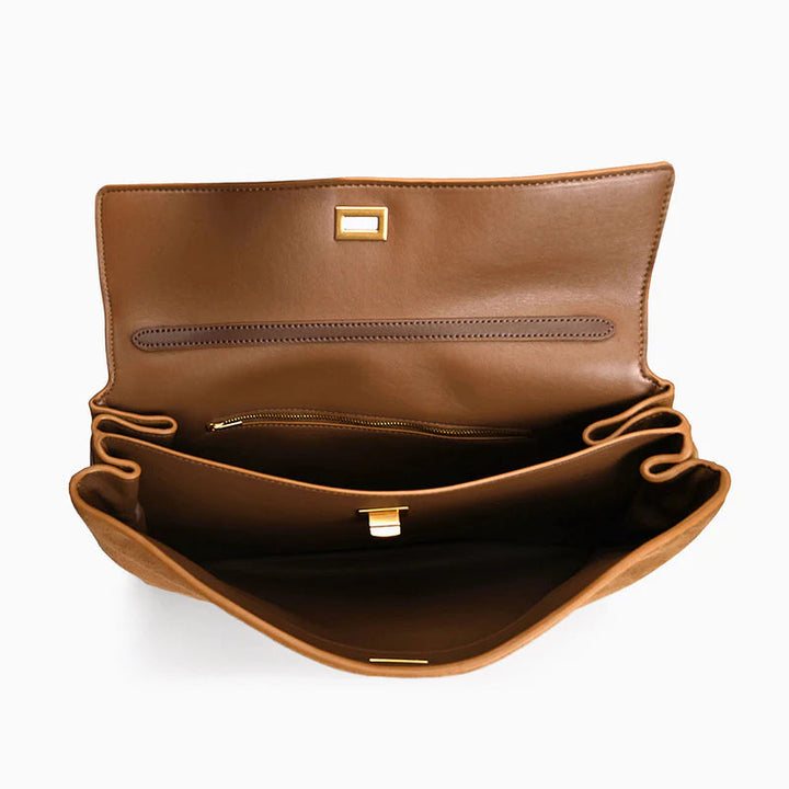 "Sac à main AMÉLIE en daim véritable, automne-hiver, élégant avec fermeture dorée et bandoulière réglable."