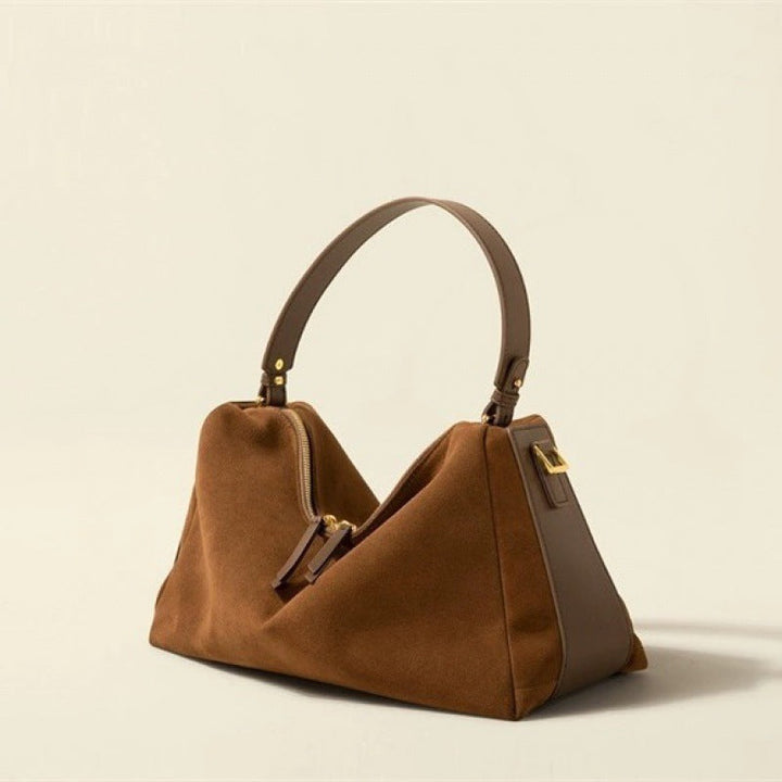 Sac à main élégant en cuir de vachette bicouche, couleur brune, avec anses renforcées et doublure en polyester.
