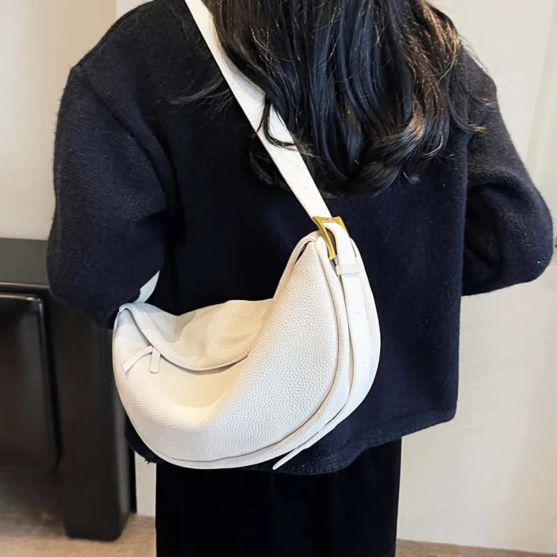 Sac banane chic porté en bandoulière par une femme, ajoutant une touche mode à sa silhouette.