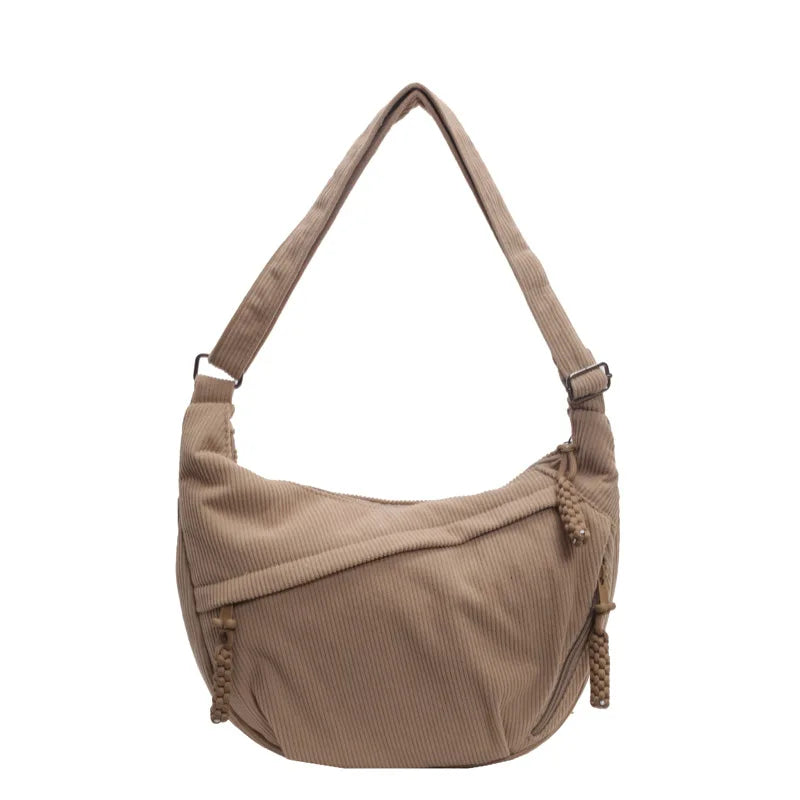 Sac banane femme en velours côtelé, multiple compartiments visibles, pratique et mode
