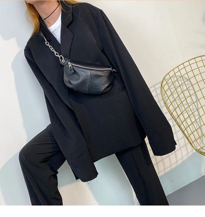 Sac banane femme noir élégant en similicuir, accessoire mode urbain et tendance.