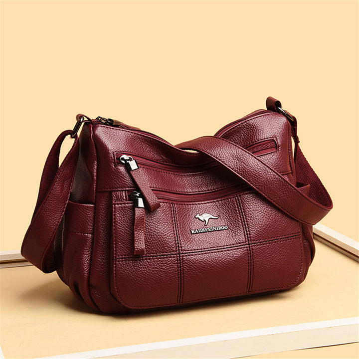Maroquinerie femme: sac bandoulière bordeaux chic en similicuir, accessoire mode indispensable.
