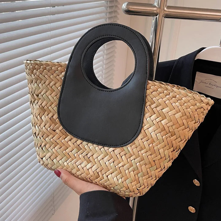 Sac bandoulière élégant pour femme, paille naturelle et détails en similicuir noir, accessoire chic.