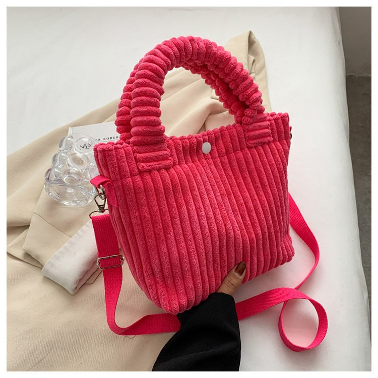 Photo d'un sac bandoulière velours côtelé tendance, idéal pour compléter une tenue chic d'automne.
