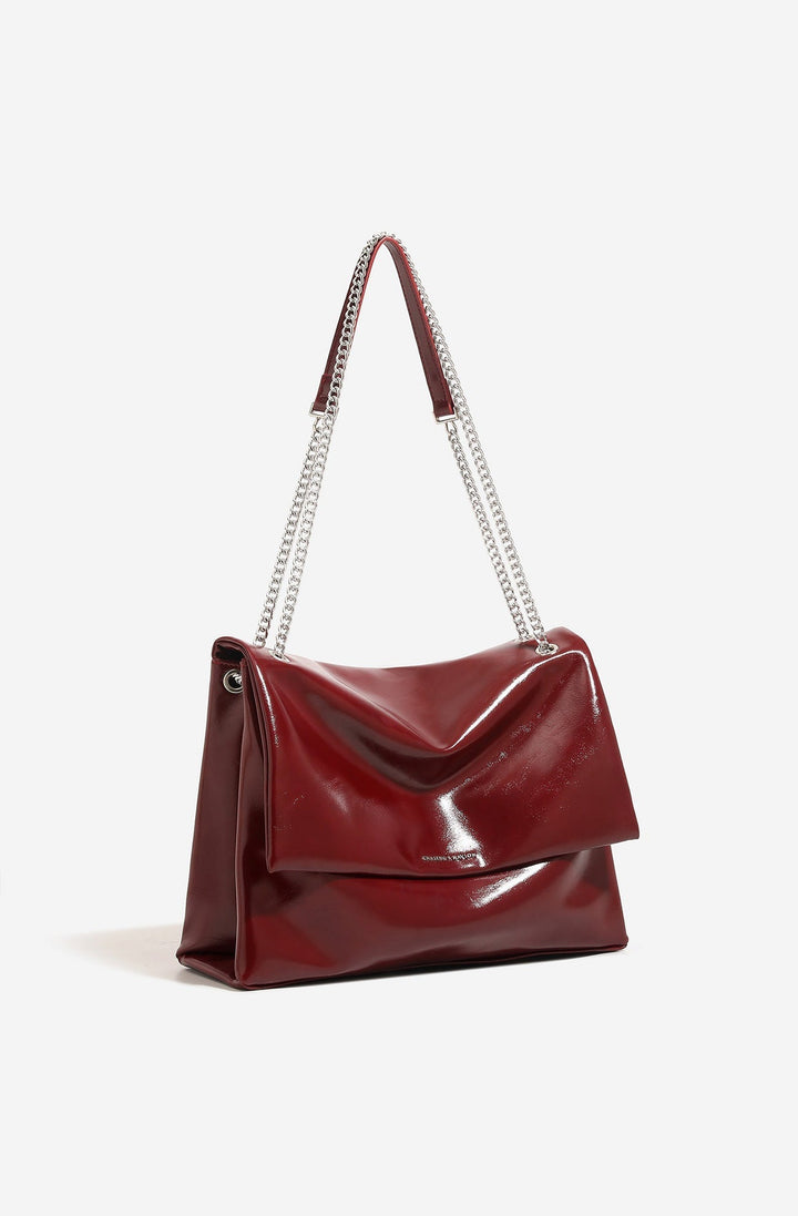 Sac bandoulière violet foncé pour femme, design élégant avec rabat et chaîne métallique.