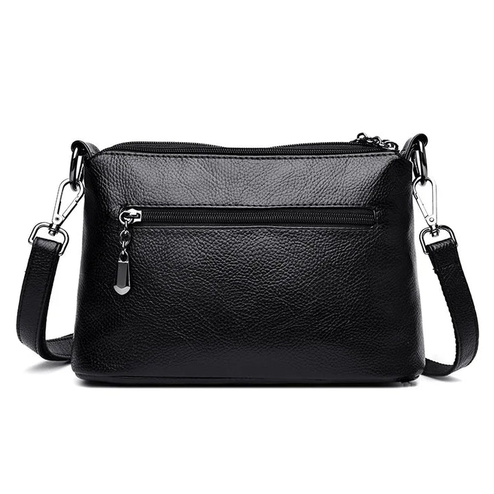 Sac bandoulière femme noir, texture effet crocodile, design compact et très élégant.