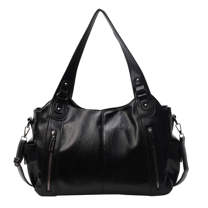 Sac bandoulière femme élégant en cuir synthétique noir, idéal pour le quotidien. Maroquinerie chic.