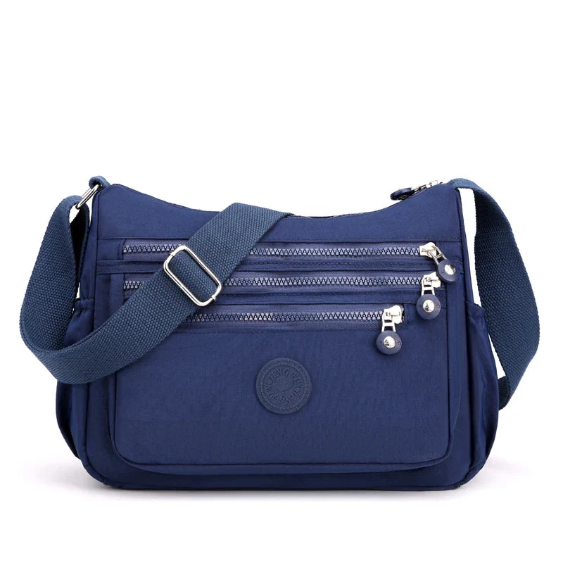 Sac bandoulière femme imperméable en nylon résistant, protège vos affaires par tous temps.