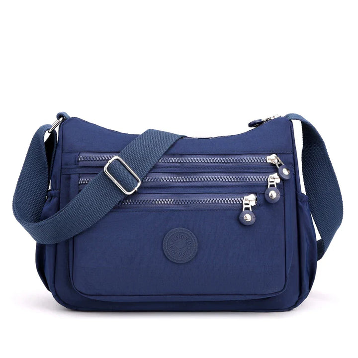 Sac bandoulière femme imperméable en nylon résistant, protège vos affaires par tous temps.