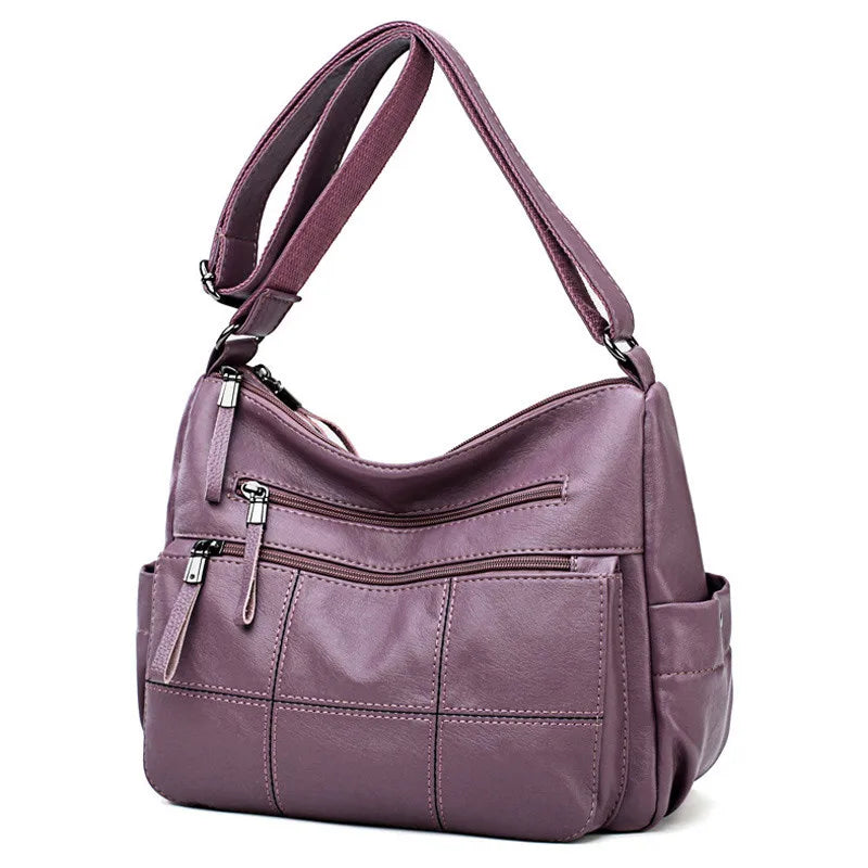 Sac besace Nexis pour femme, similicuir noir, avec bandoulière réglable, idéal pour le quotidien.