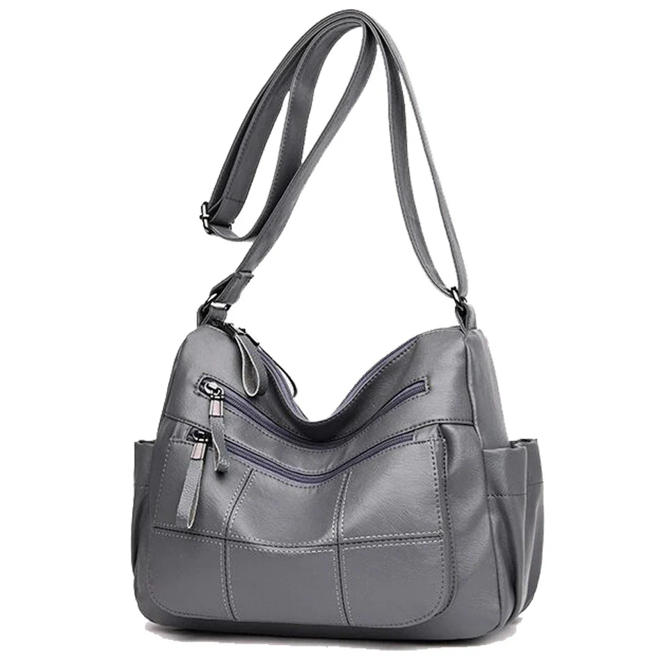 Accessoire femme: Sac à bandoulière Nexis gris, similicuir souple, parfait pour un look décontracté chic.