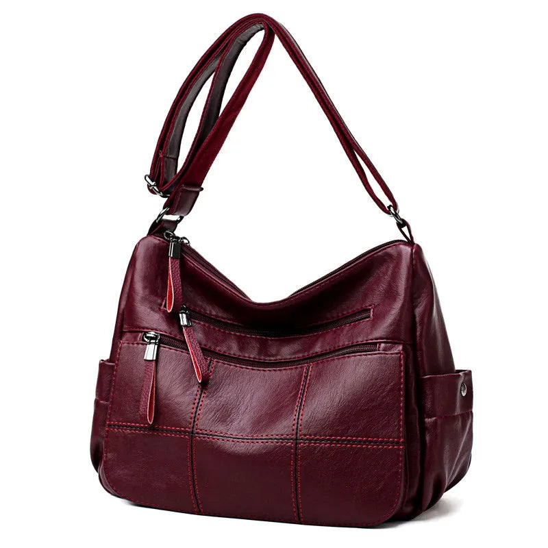 Sac à bandoulière femme Nexis, design épuré en similicuir, avec fermeture éclair sécurisée.