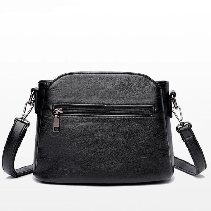 Sac à main bandoulière noir chic pour femme, design moderne et raffiné en similicuir, parfait pour la mode.
