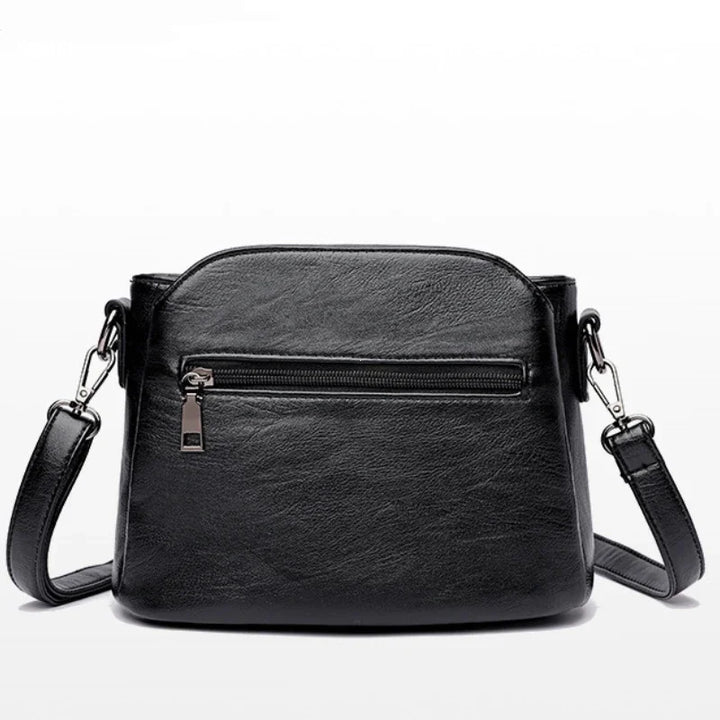 Sac à main bandoulière noir chic pour femme, design moderne et raffiné en similicuir, parfait pour la mode.