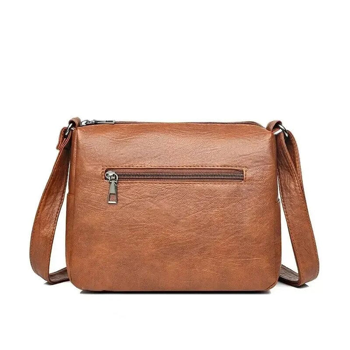 Sac bandoulière femme vintage, compact mais spacieux, inscription 'Love', élégant en cuir.