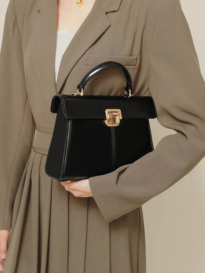 Plusieurs sacs bandoulières en cuir de différentes couleurs (noir, marron, bordeaux) alignés.