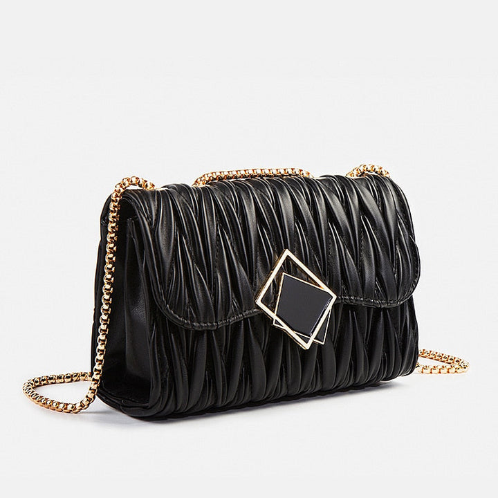 Sac bandoulière élégant noir et doré pour femme, parfait pour soirées et événements. Accessoire mode en cuir synthétique.