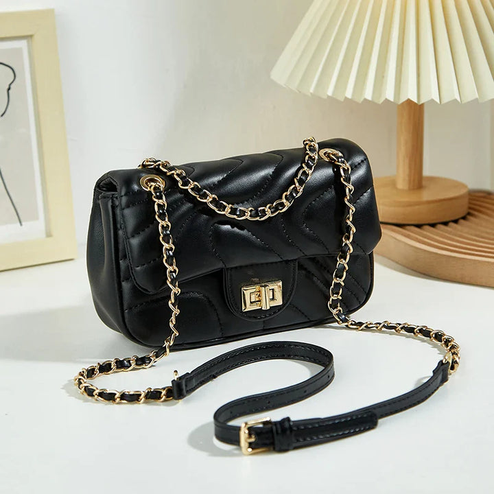Sac à bandoulière matelassé chic en similicuir noir pour femme, accessoire de mode élégant.