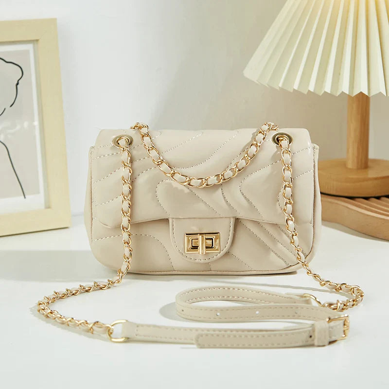 Sac à bandoulière en similicuir blanc matelassé, design moderne et chic pour femme.