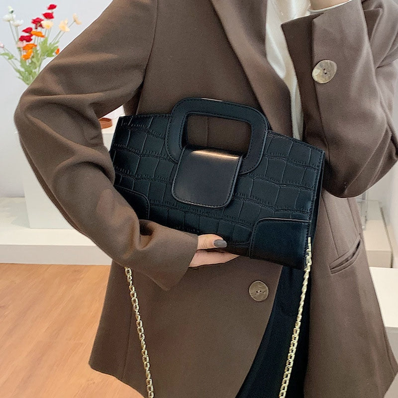 Sac femme noir élégant, bandoulière avec chaîne dorée, idéal pour soirées ou tenue quotidienne chic.