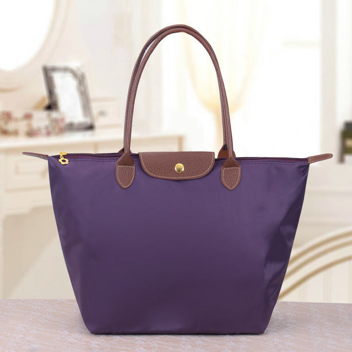Sac à bandoulière femme au design Oxford classique. Accessoire mode élégant et intemporel pour un look raffiné.