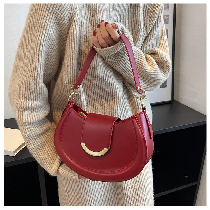 Sac bandoulière rond élégant pour femmes en cuir souple, couleur unie, style chic et moderne.
