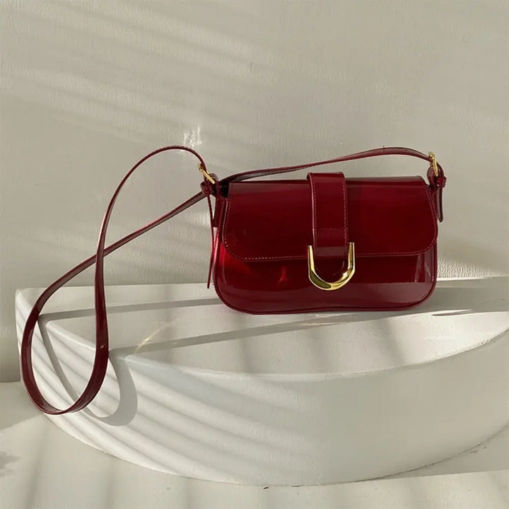 Gros plan sur le fermoir et les détails du sac bandoulière rouge Cléa, touche chic pour femme.
