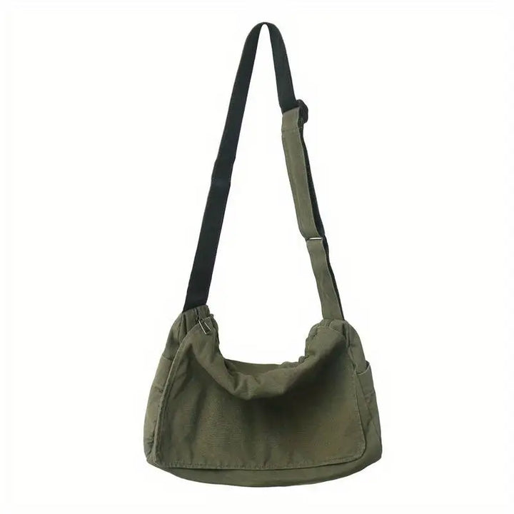 Sac bandoulière pratique en tissu léger avec multiples compartiments, parfait pour l'organisation.
