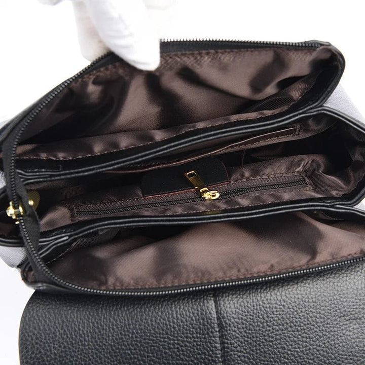 Sac besace Alice noir en cuir PU, avec détails dorés, mode femme sophistiquée.
