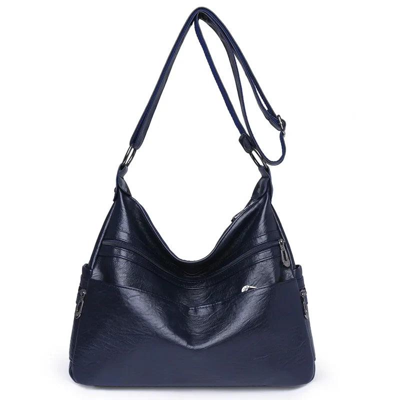 Sac bandoulière femme élégant en similicuir souple, compartiments organisés, style moderne.
