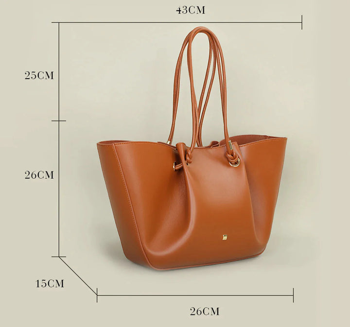 Sac cabas femme Colette en cuir vegan bleu marine, avec finitions dorées, un accessoire chic.