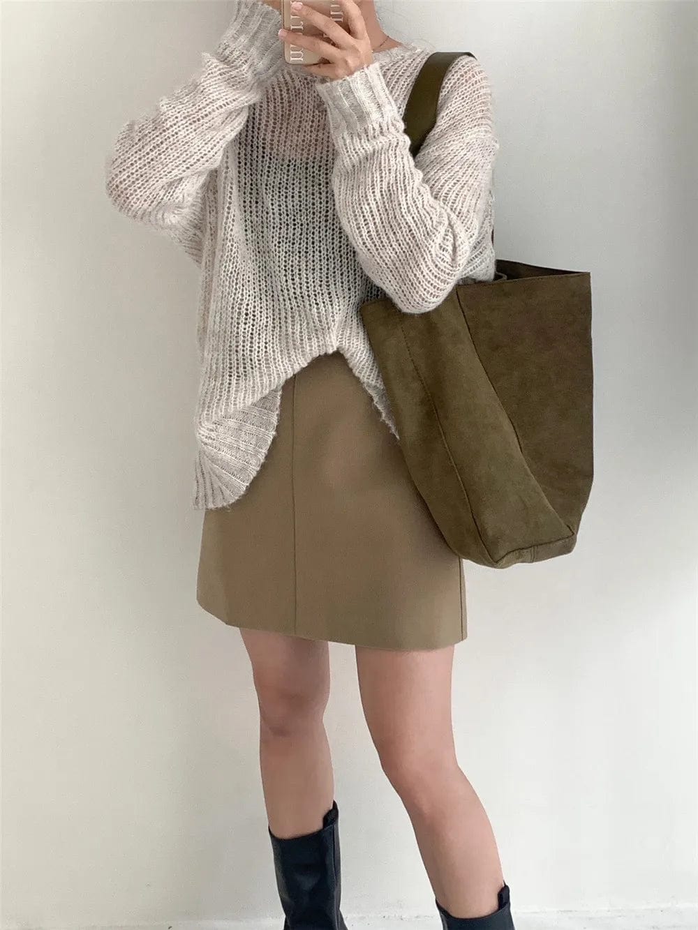 Mode féminine : sac cabas en faux daim marron porté à l'épaule, accentuant un style raffiné.