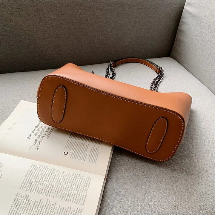 Gros plan sur la fermeture éclair dorée et les finitions d'un sac cabas femme en cuir vegan noir