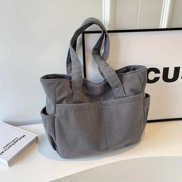 Grand sac épaule en velours côtelé, parfait pour le voyage, les études ou le travail.