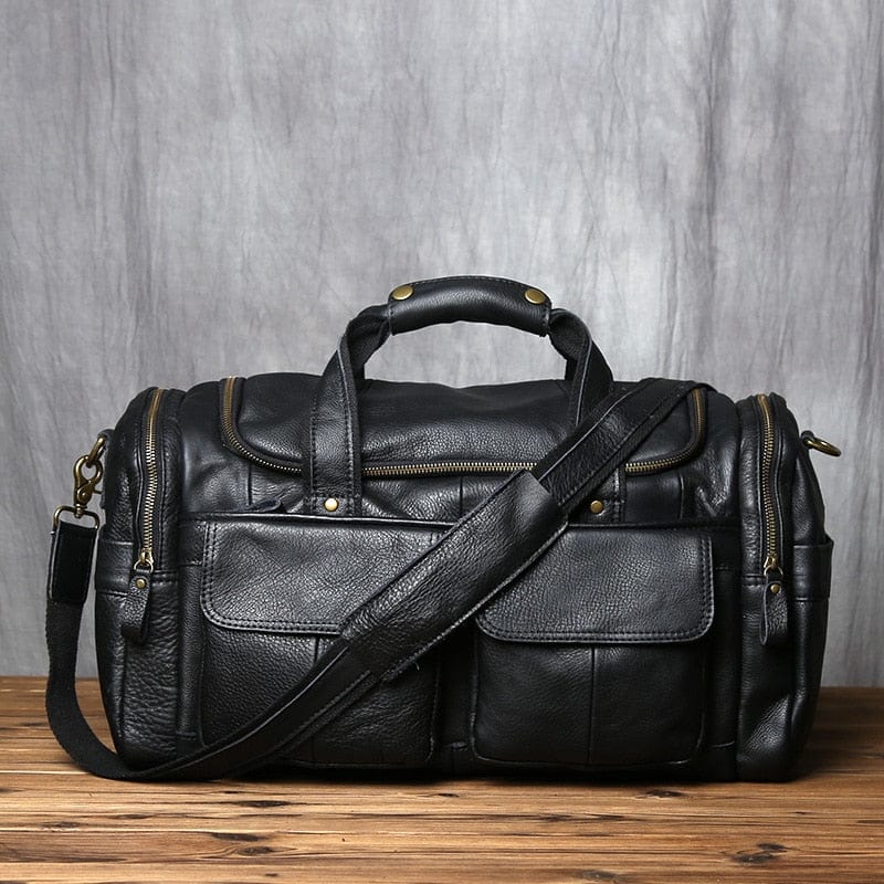 Sac de voyage homme noir en cuir véritable, élégant et spacieux, parfait pour les déplacements.
