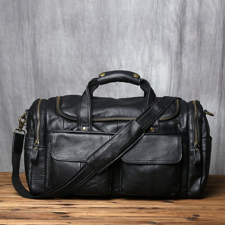 Sac de voyage homme noir en cuir véritable, élégant et spacieux, parfait pour les déplacements.