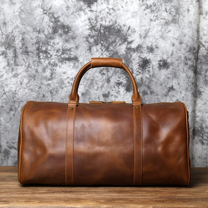 Sac de week-end en cuir marron, avec poignées renforcées, prêt pour l'aventure